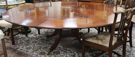 A modern Regency style Jupe style mahogany extending dining table, W.230cm